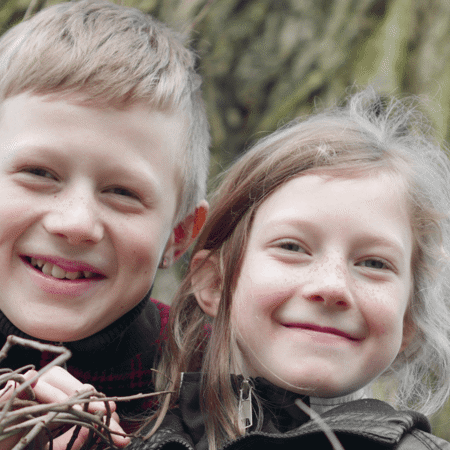 brother and sister smiling