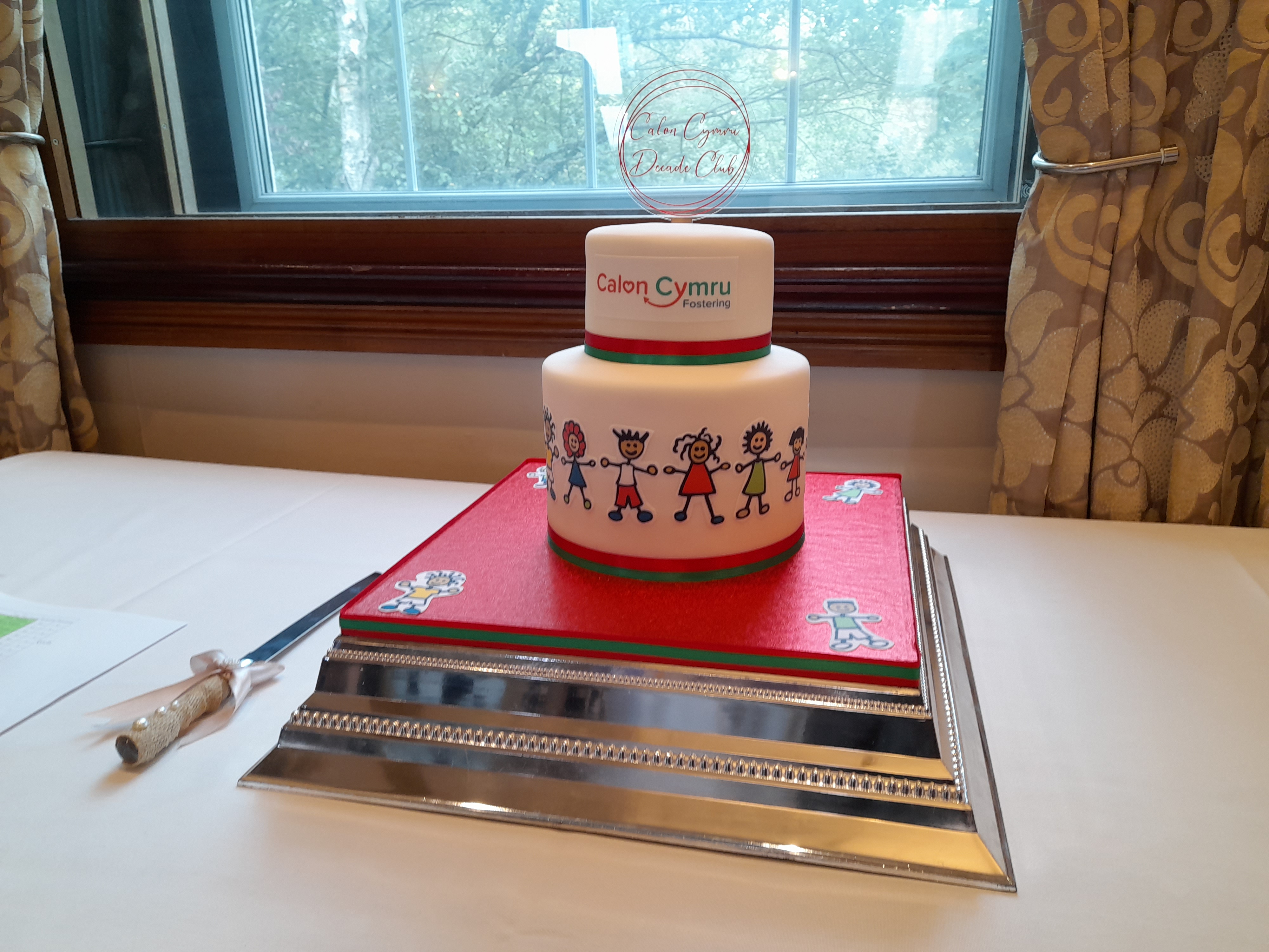 Two tier cake decorated with Calon Cymru branding