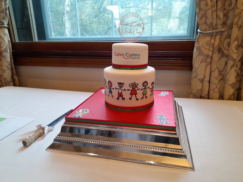 Two tier cake decorated with Calon Cymru branding