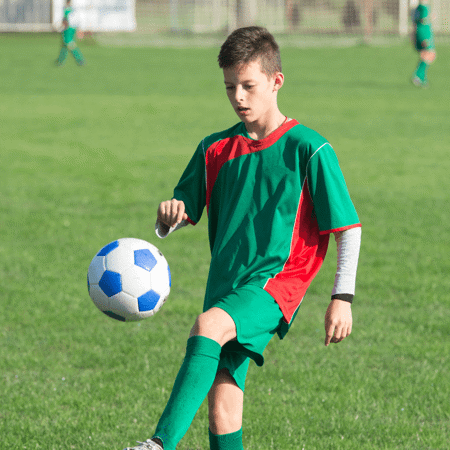 Boy flaying football