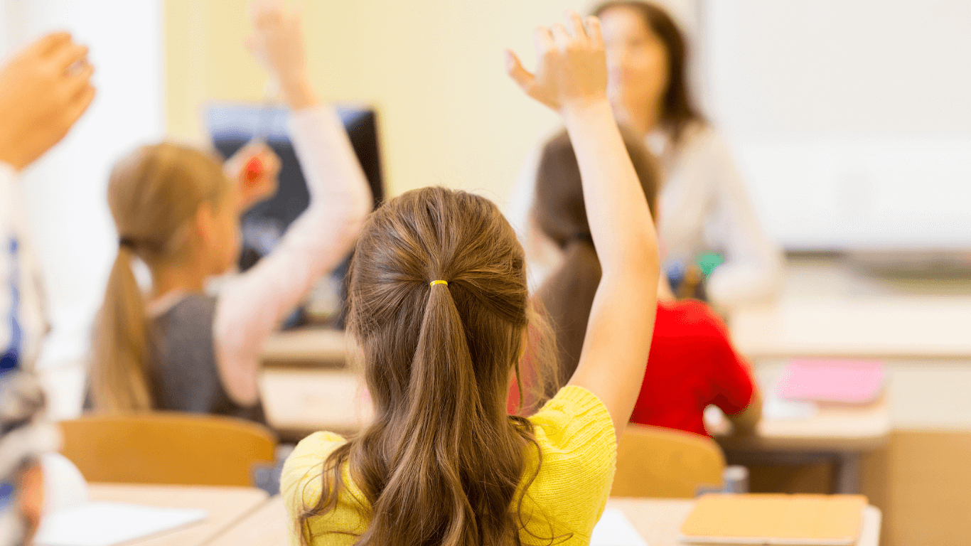 Foster girl raising hands to ask a question